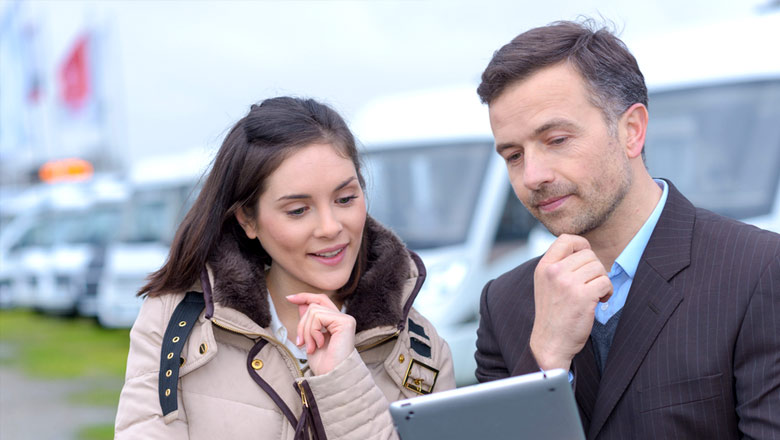 couple looking at a tablet for an RV purchase