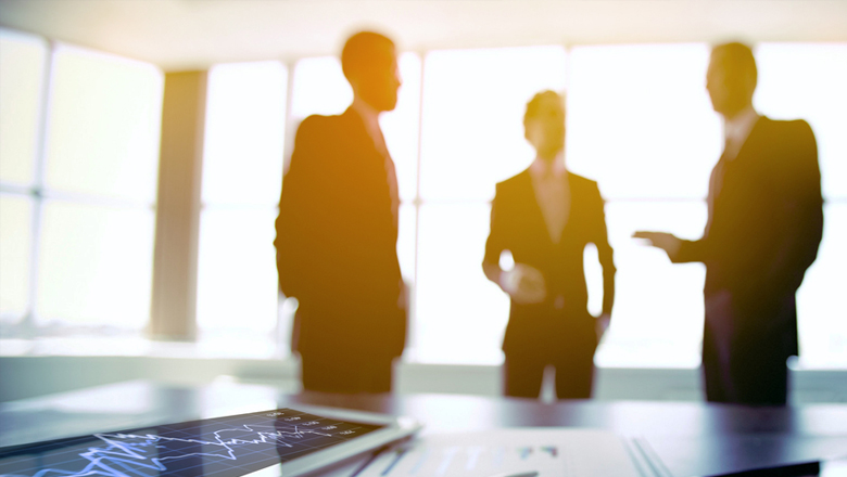 Blurry image of three men talking