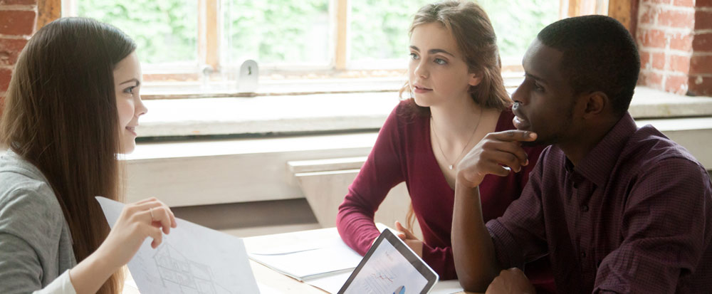 Three young adults discussing a home purchase