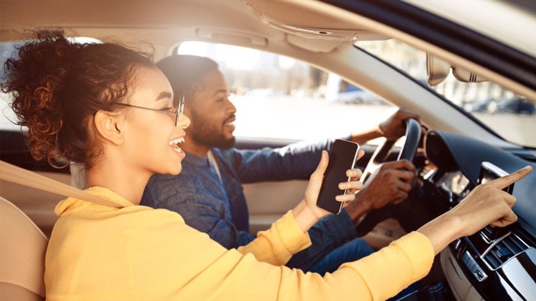 couple driving a new car