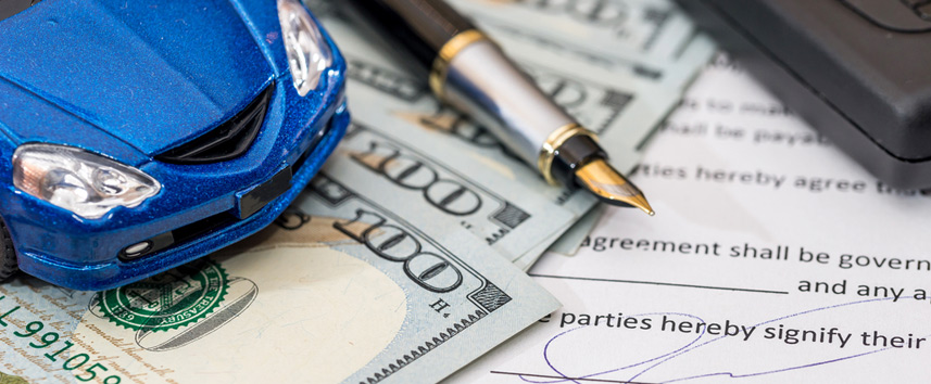 toy car, money and pen on a desk