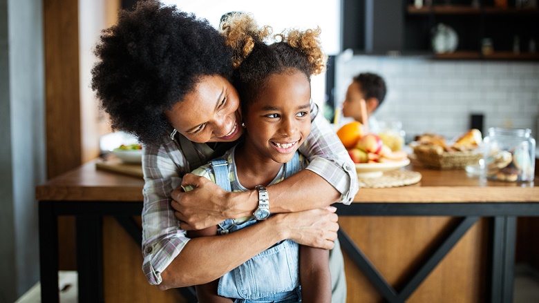 Mother hugging daughter