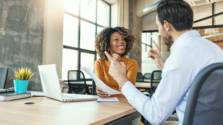 two people at table talking