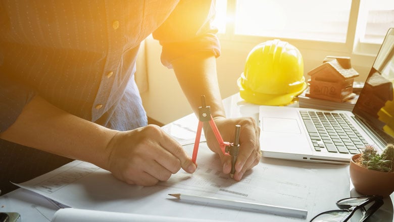 person using drawing compass