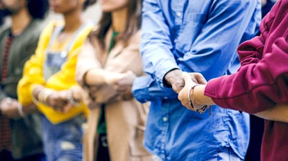 Group of people holding hands