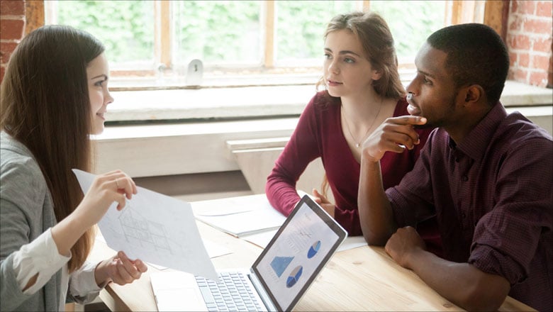 Three young adults discussing a home purchase