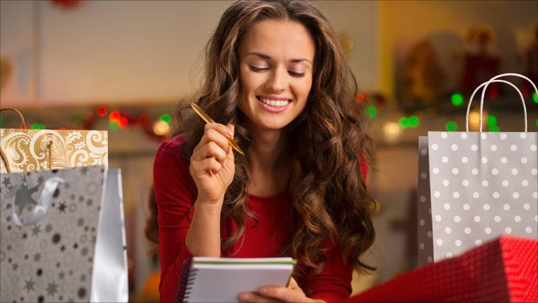 Happy woman checking her Christmas list