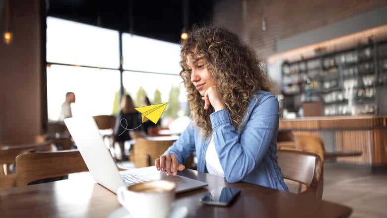 woman in coffee shop looking at laptop