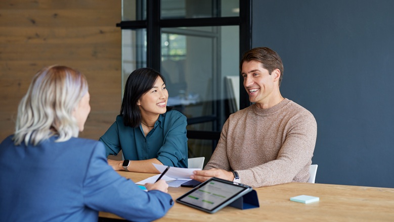 Couple at a table checking interest Rates