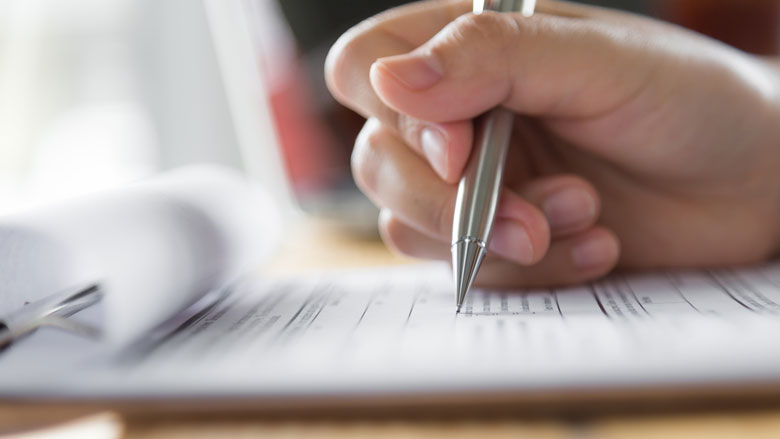 Hand with pen and paper