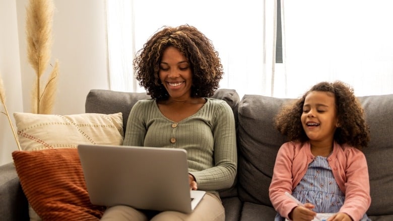 mom and young daughter on couch