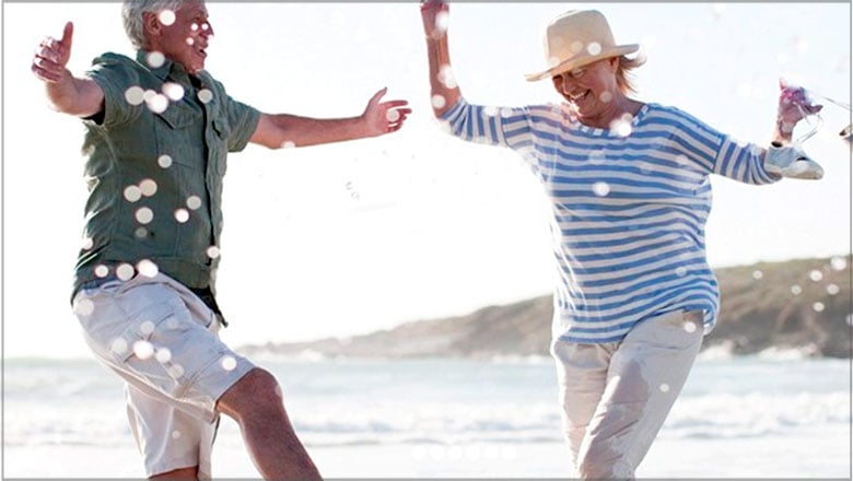 Mature couple playing at the beach