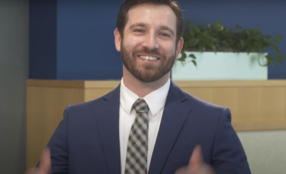 Man in a suit with a big smile