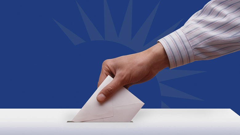 Hand casting a voting ballot