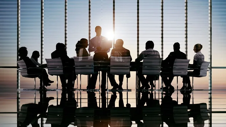 diverse group of people at board room table