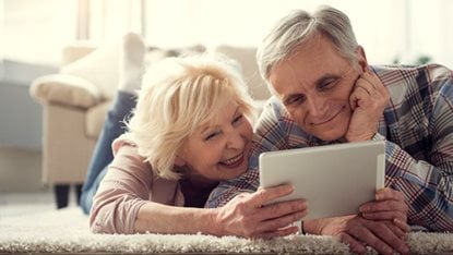 mature couple looking at a tablet