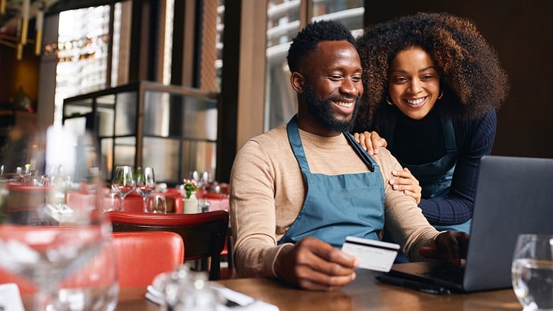 Business owners holding credit card