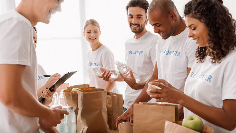 people packing bags with food