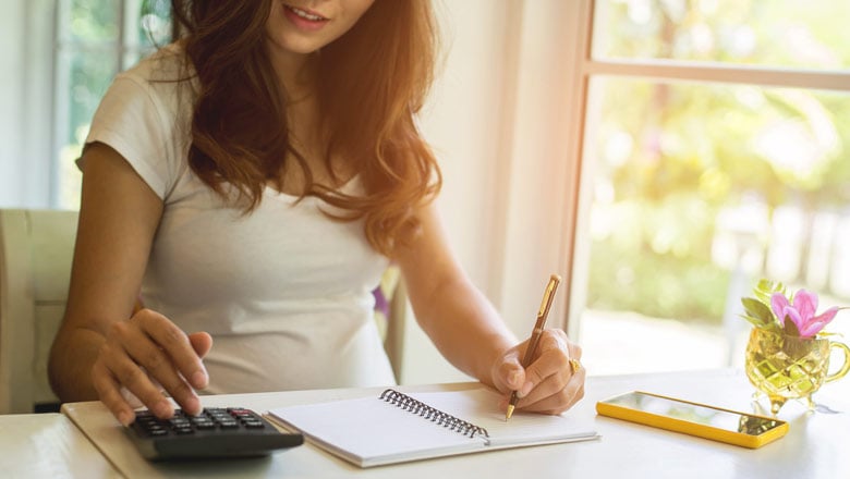 Woman with a calculator and notebook