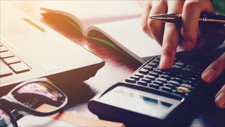 Mans hand using a calculator