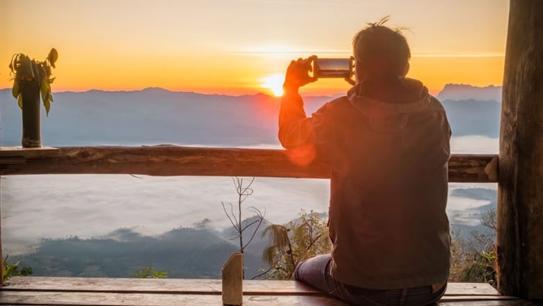 Man taking photo of a sunset