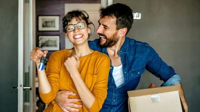 happy couple moving in to new house