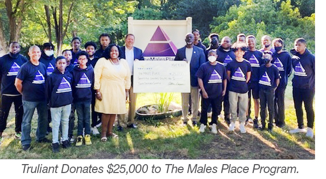 group of people from males place accepting check from truliant