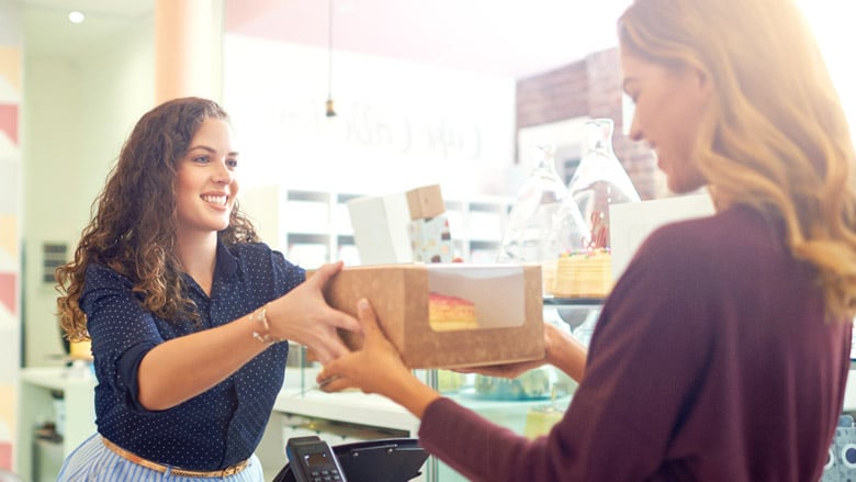 two women handing off box