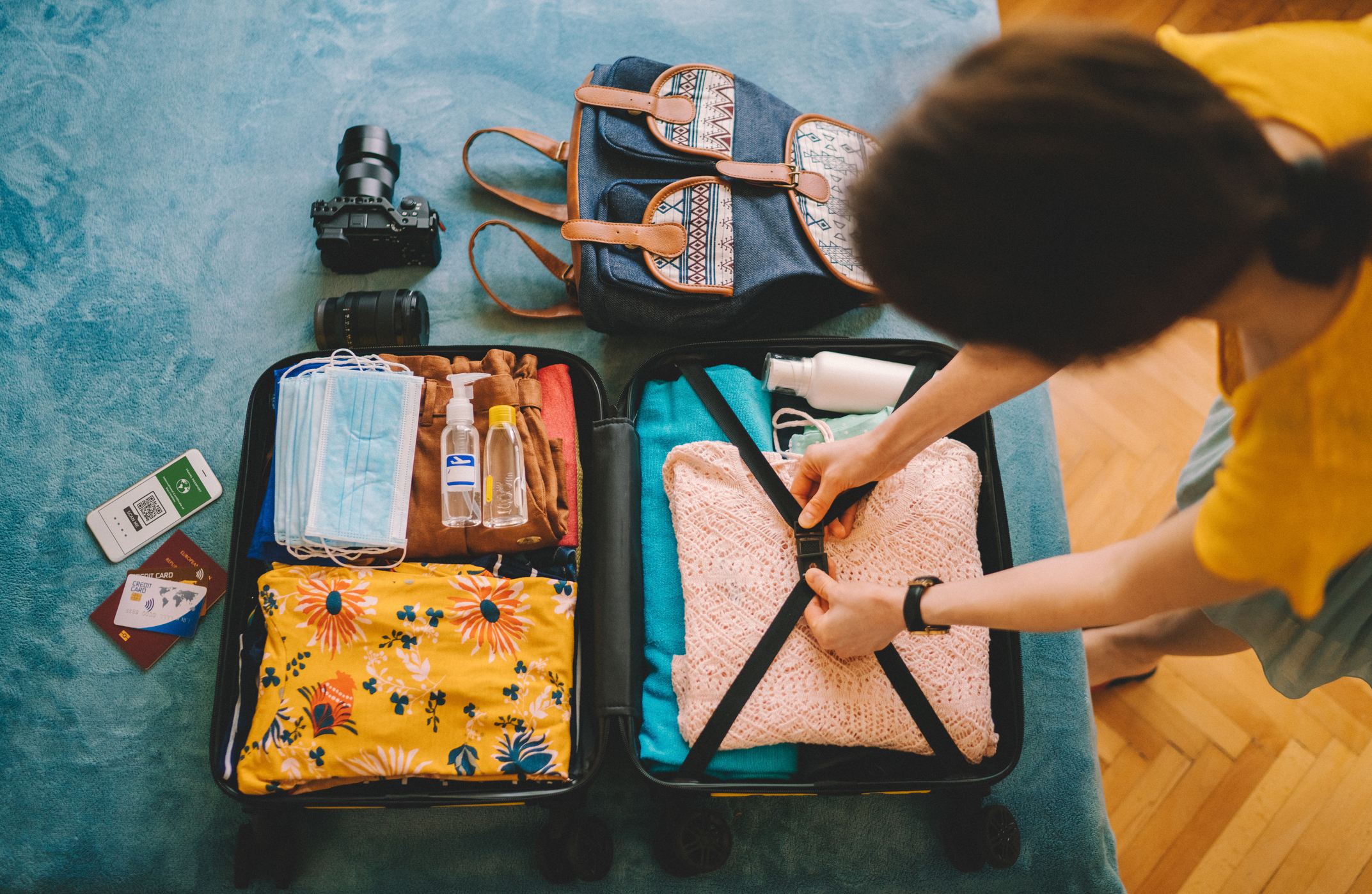 Person packing luggage for trip