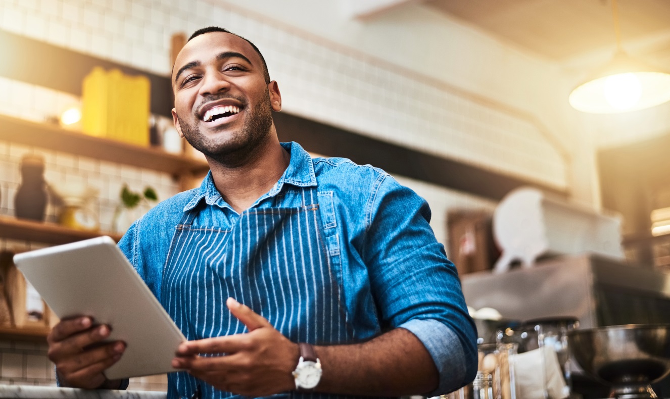 African man with tablet at his coffee shop