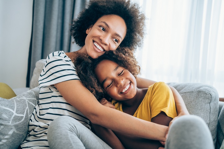 Mother and child hugging on the couch