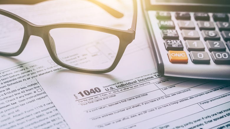 Glasses and Calculator on a 1040 Tax Document