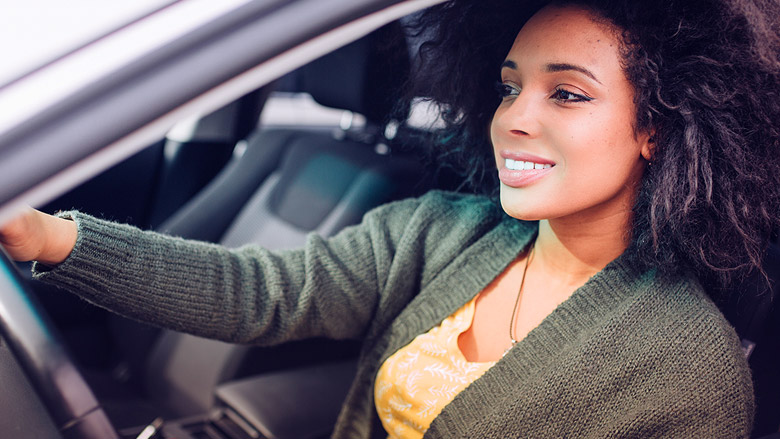 Women driving car with window down