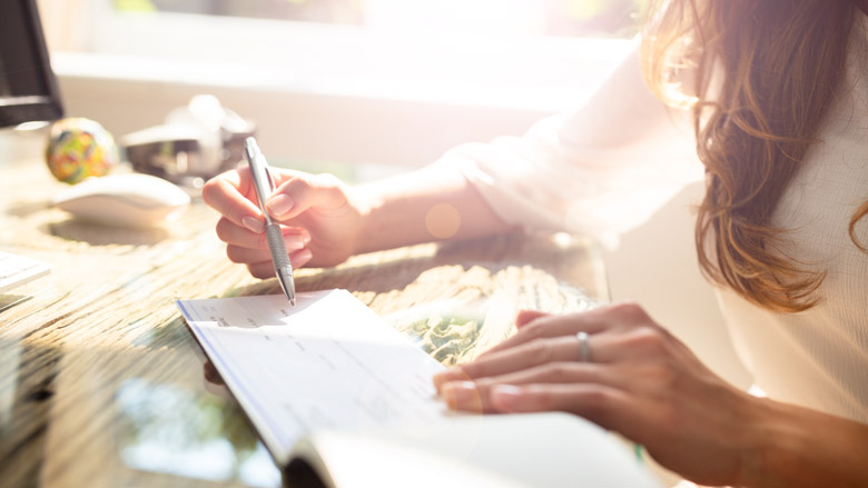 Woman looking at a check book