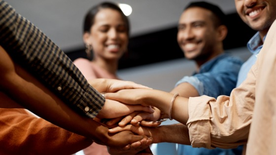 group of people joining hands
