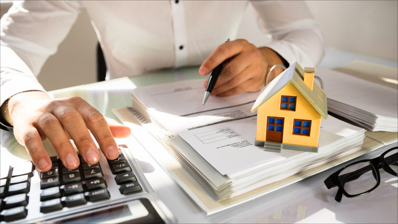 Man at a desk calculating property tax