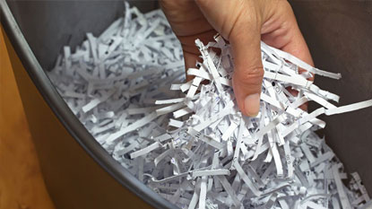 Hand with shredded paper