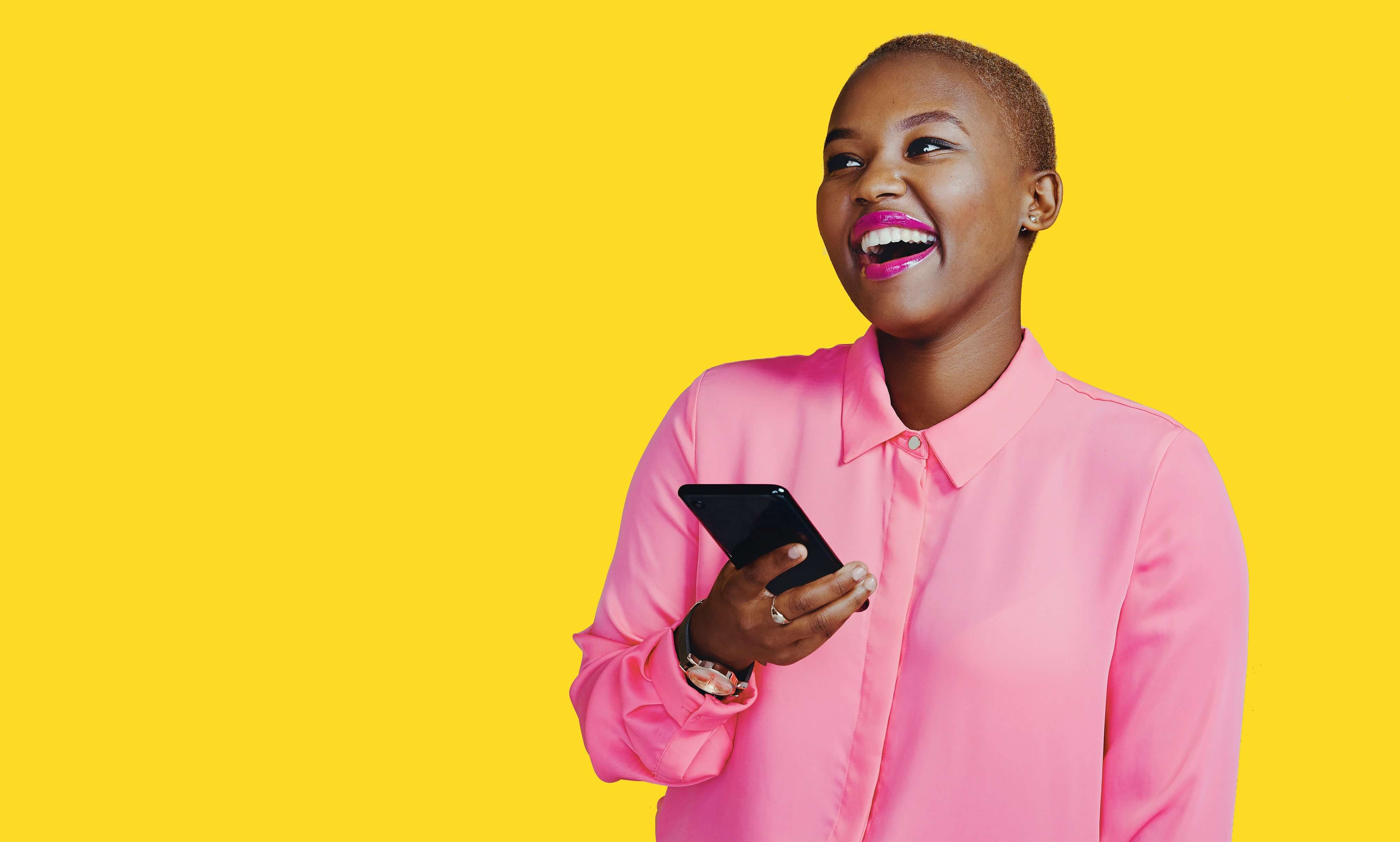 african american woman smiling with phone.
