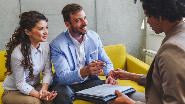 mortgage officer with a couple doing paperwork