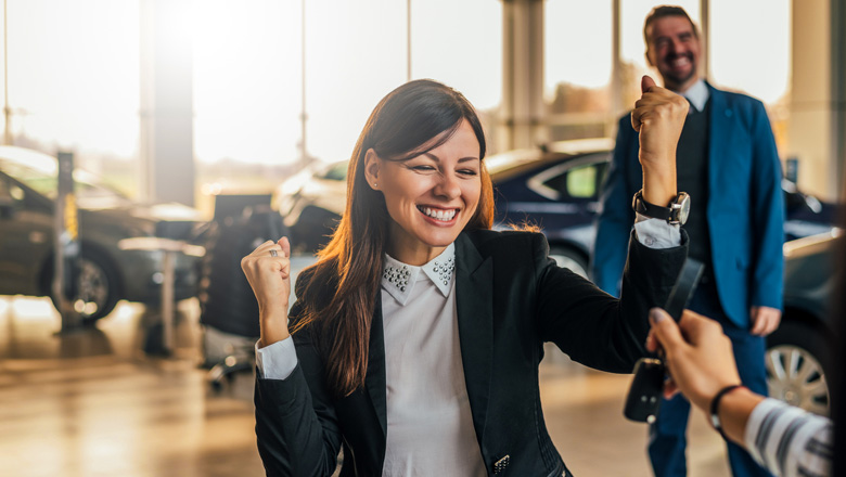 Woman getting the keys to her dream car