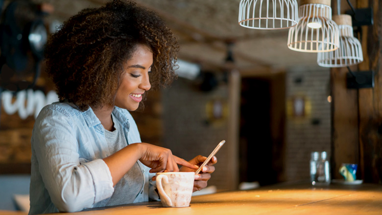 Woman mobile banking at counter