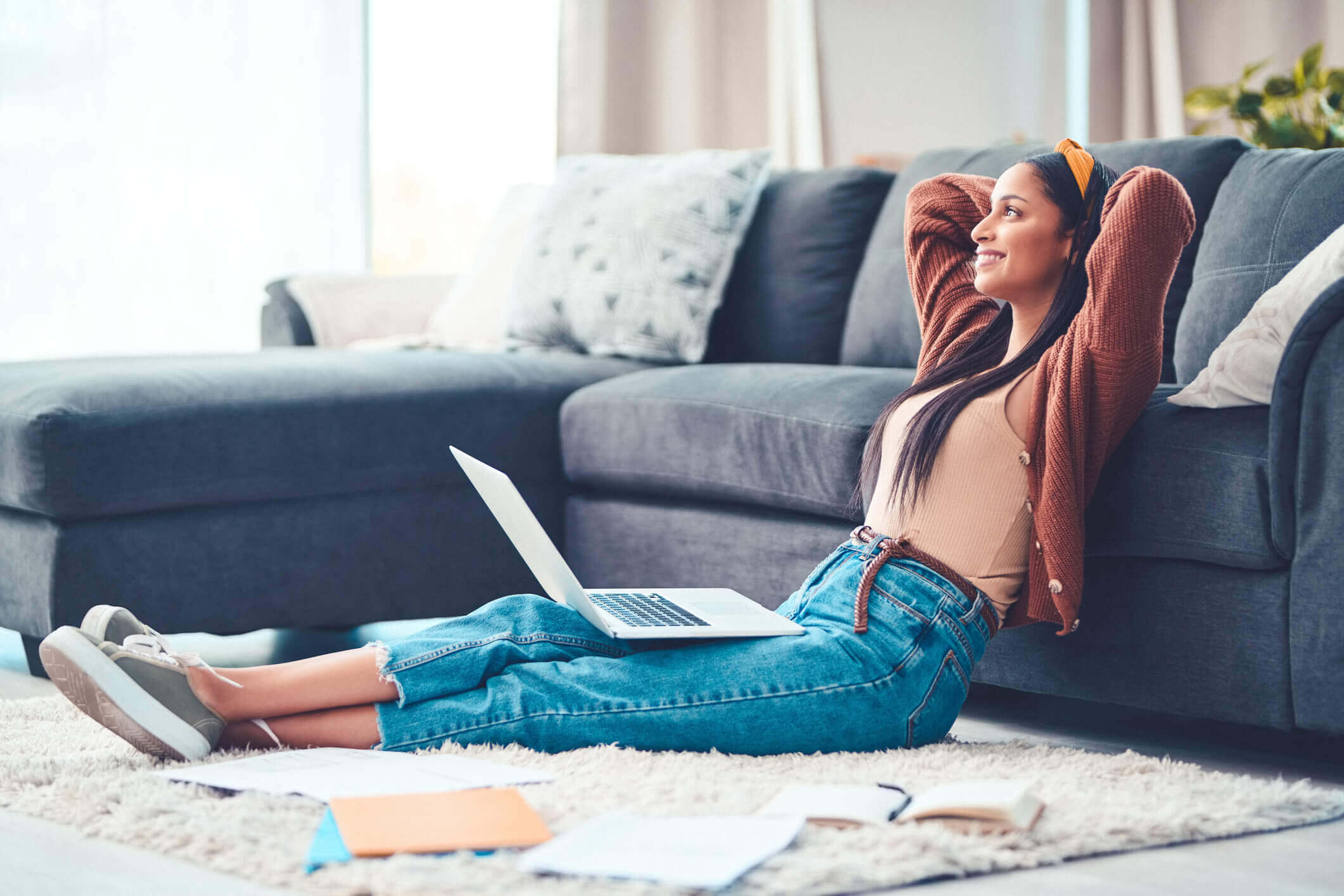 Woman sitting against a couch relaxing