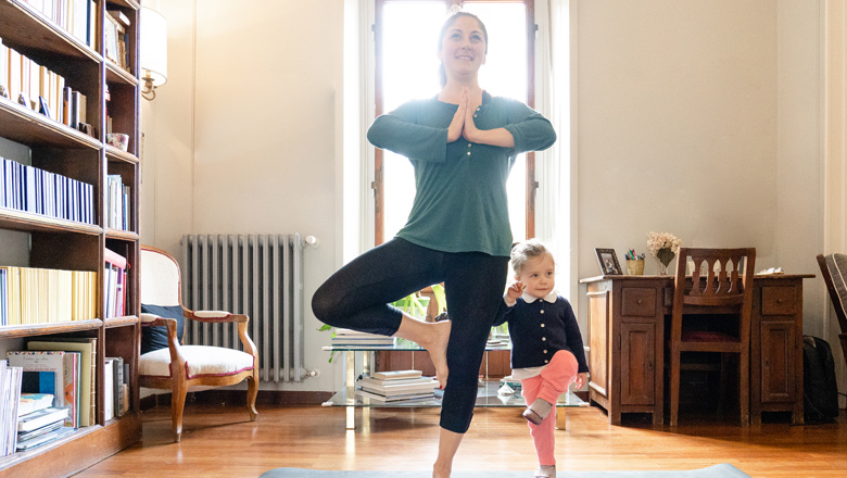 mom and young daughter doing yoga