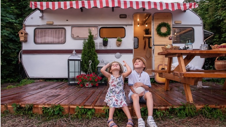 Kids in front of a camper