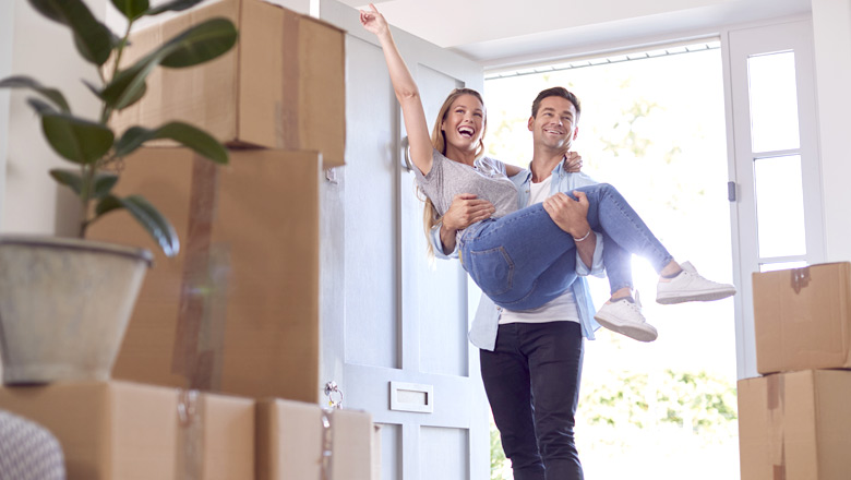 Couple entering their new home for the first time