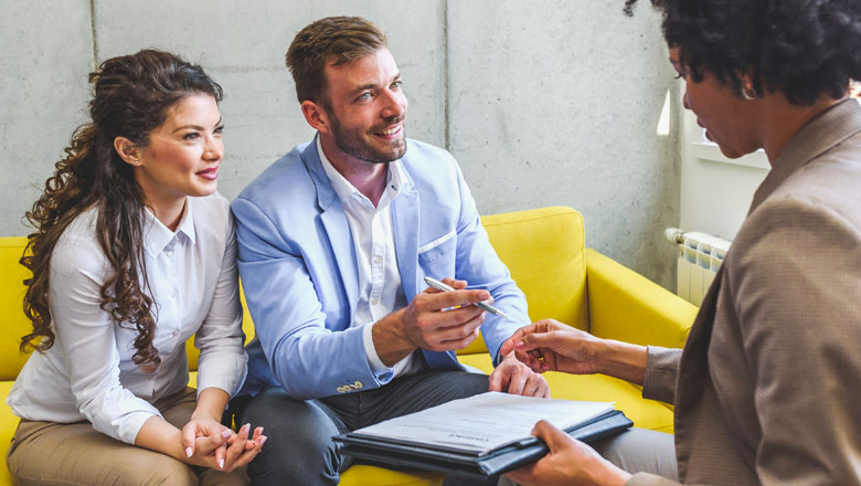Mortgage officer with a couple doing paperwork