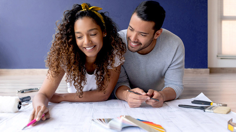 Couple on floor looking at design options