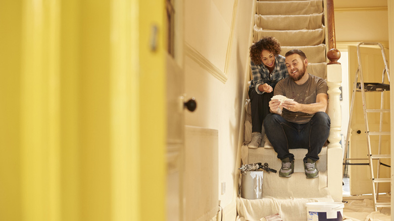 Couple on the stairs with paint samples