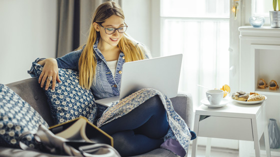 Woman on couch with computer