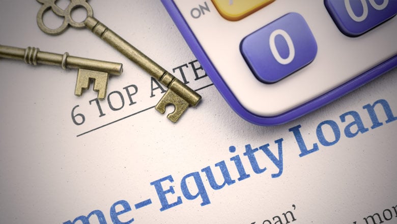 Keys and calculator laying on a home equity loan p